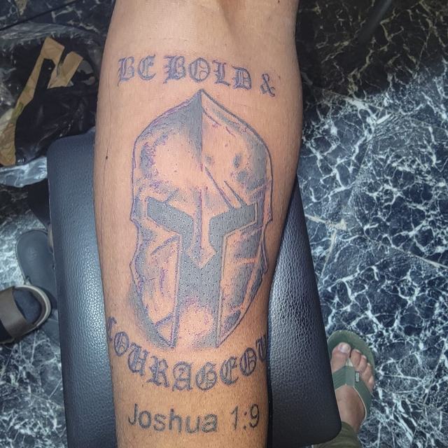 Spartan helmet forearm tattoo